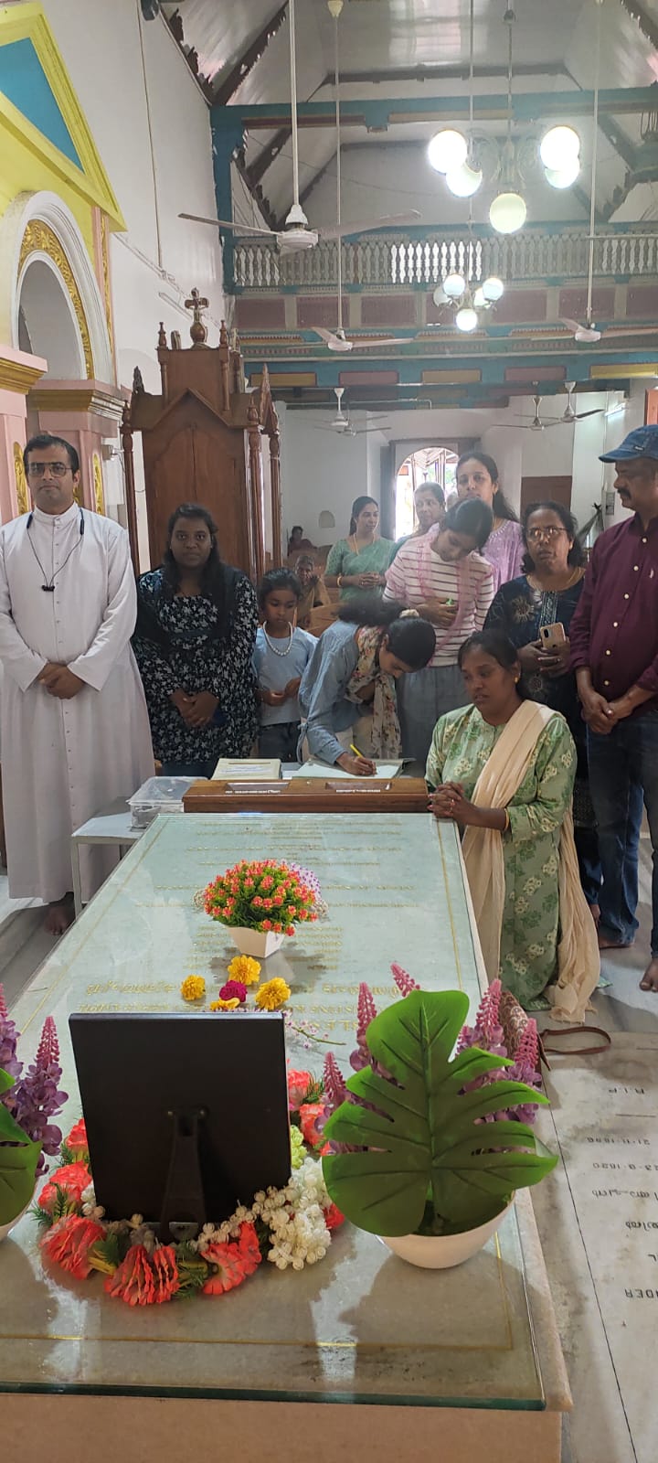 Fr Franco from the diocese of Ramanathapuram with a group of pilgrims at the tomb of Blessed Kunjachan on 27 June 2026
